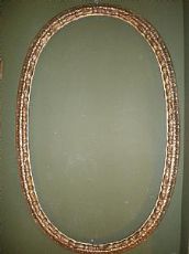Cornice ovale scolpita
